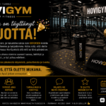 HoviGym 2 vuotta – tumma ja blurattu kuntosali tausta sekä kynttilällä varustettu kakkonen cupcake päällä